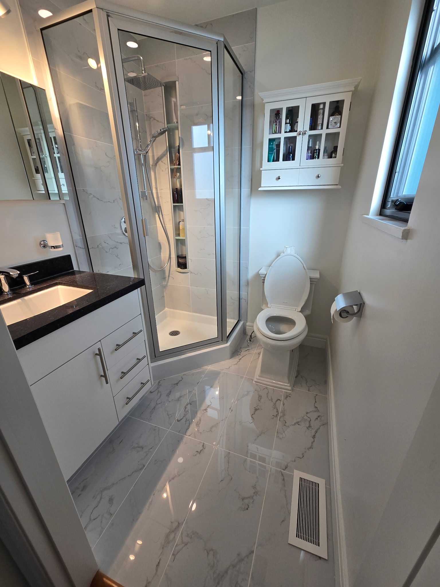 Deteriorated grout refreshed and failed caulking replaced — shower surround restored to a clean, watertight finish.