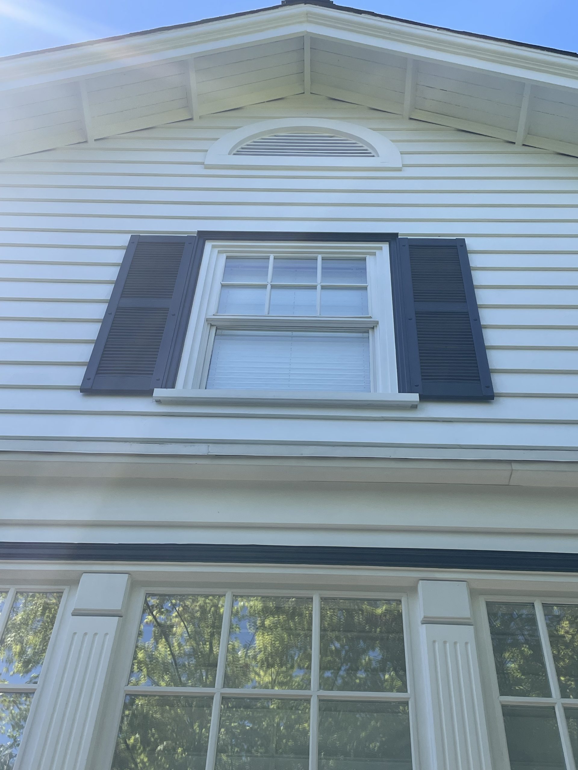 Rotted 2nd-floor window casing stripped back, rebuilt with durable trim, and finished with a clean coat of paint.