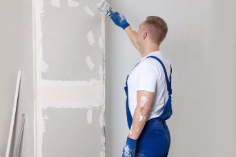 man-plastering-wall-with-putty-knife-indoors-home-2026-01-23-19-10-34-utc